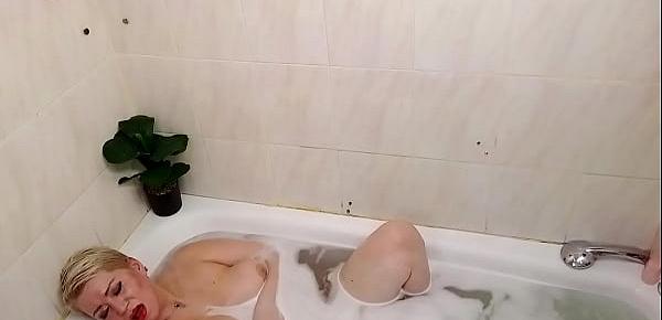  Busty mature bitch takes a shower, masturbates and sucks cock in the bathroom...
